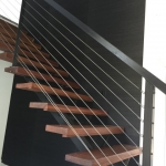black grasscloth wallpaper in stairway - Gold Coast