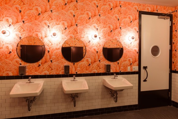 Shuffleboard Venue At Royal Palms Using Flamingo Wallpaper In The Bathrooms 
