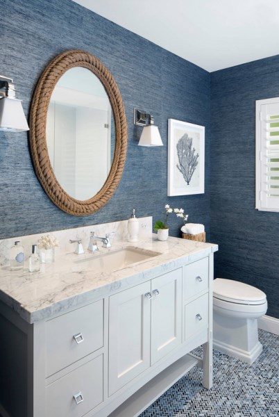 The natural blue grasscloth wallpaper teams so well with the large rope mirror and white cabinetry